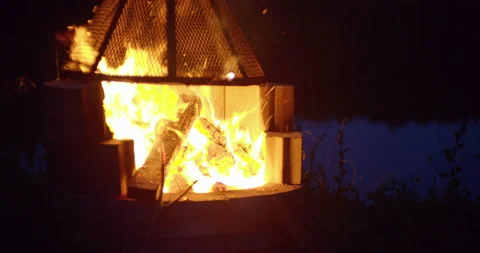 Campfire pit by the lake at night Stock Footage 130928245