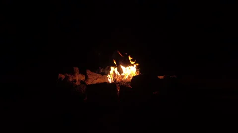 Campfire in ring of stones burning and sparking in the black of night Stock Footage 147237977