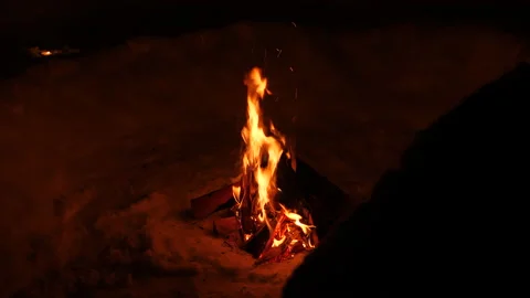Campfire in snow by night Video stock 146133213