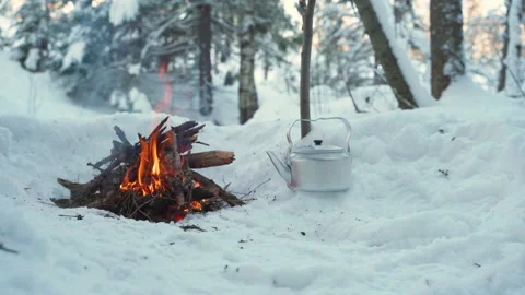 Campfire in winter forest and camping kettle Video stock 148150302
