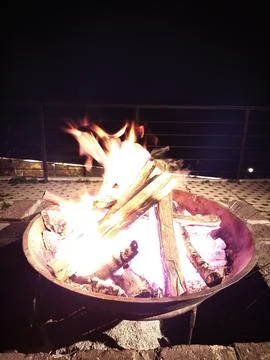 Camping Bonfire With Golden Flames on a Dark Night Scene Stock Photos