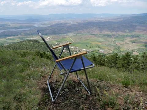 Camping chairs. beautiful view from the valley. Small towns and villages below. Stock Photos