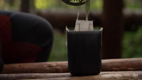 Camping coffee. Exploring the art of brewing coffee in the forest Stock Footage 316053757