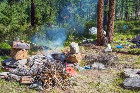 Camping for cooking on the fire in the cauldrons. Stock Photos