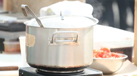 Camping cooking, fire under black pot, vintage cook healthy food, home made food Stock Footage 65118813