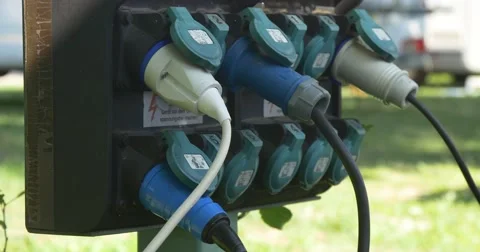 Camping electricity adapters plugged into sockets Stock Footage 66394047