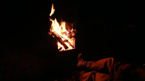 A camping fire is crackling and sending sparks into the air.  Stock Footage 251757879