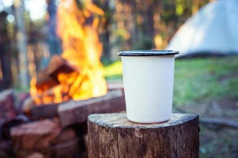 Camping fire drinking cup. Stock Photos
