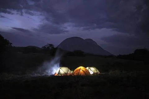 Camping by fire Stock Photos