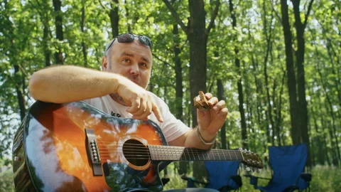 Camping in the forest, delicious food while relaxing, a man eats food. Stock Footage 202247974