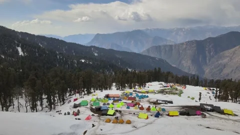 Camping ground campsite on the snow surrounded tall green pine trees. hikers Stock Footage 157932233