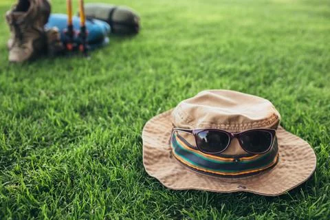 Camping hat with sunglasses on the grass 写真素材