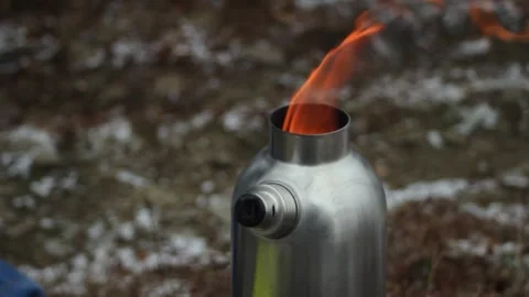 Camping kettle. Heating water on fire with a camping heater. Tongues of flame Stock Footage 304878711