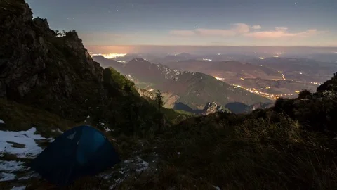 Camping in mountains under night sky with moonlight time lapse Stock Footage 69793091