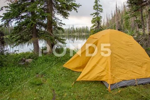 Camping in the Mountains in Yellow Tent Stock Photos
