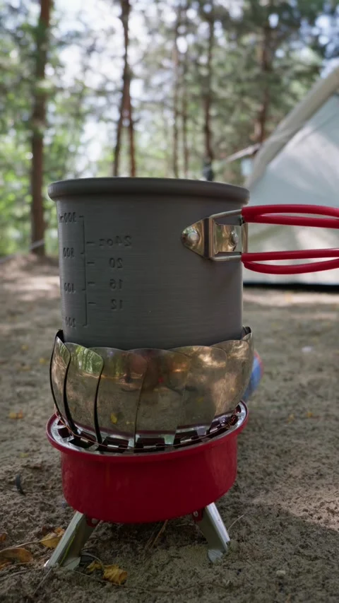 Camping Pot Boiling Water on Portable Gas Stove at Forest Campsite Stock-Footage 341996424