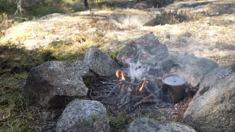 Camping Pot Cooking Over Campfire Among Rocks 스톡 동영상 333580997