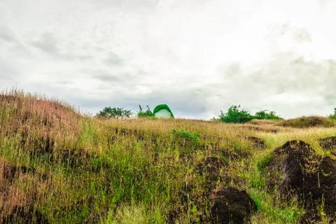 Camping solo at mountain top with dramatic sky Фото