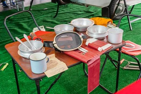 Camping Table Setup with Outdoor Dining Utensils on Green Turf Stock Photos