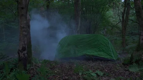 A camping tent exploding in a forest Stock Footage 251824027