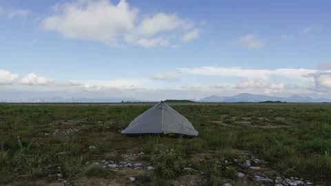 Camping Tent in Open Wilderness Under Moving Clouds Timelapse Stock Footage 326698786