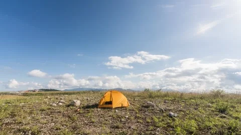 Camping Tent in Open Wilderness Under Moving Clouds Timelapse Stock Footage 326699900