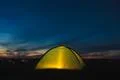 The camping tent stand by picturesque night sky with stars above foggy land.. Photo