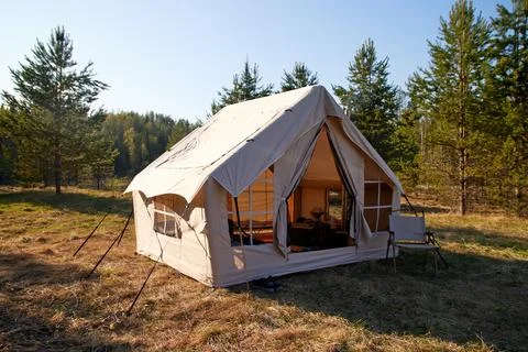 Camping tent under the pine forest. Inflatable tent Photos