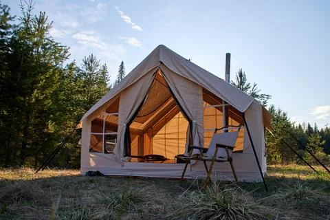 Camping tent under the pine forest. Inflatable tent Photos