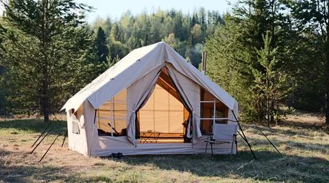 Camping tent under the pine forest. Inflatable tent Photos