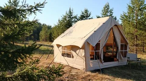 Camping tent under the pine forest. Inflatable tent Photos