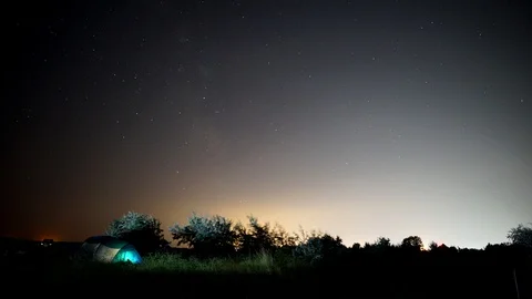 Camping under night sky timelapse Stock Footage 99429543