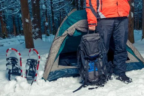 Camping in the winter forest, a man with a backpack Stock Photos