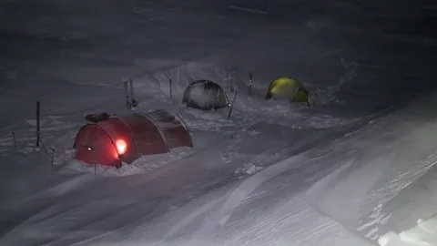 Campsite in snowstorm at night Stock Footage 79322075
