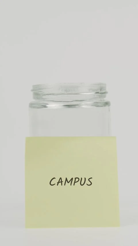 Campus text or word on yellow sticky note attached to glass jar with hand Stock Footage 311686345