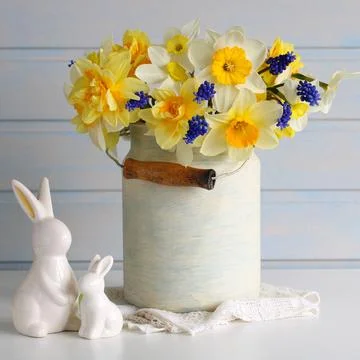 Can of daffodils and an Easter bunny. festive background, composition. spring Stock Photos