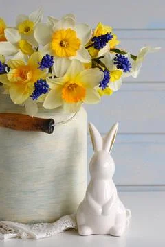 Can of daffodils and an Easter bunny. festive background, composition. spring Stock Photos