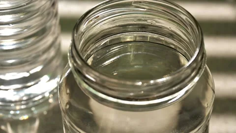  can of drinking water stands on the table close-up Stock Footage 219634574