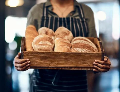 Can I interest you in a sample. a woman holding a selection of freshly baked Stock Photos
