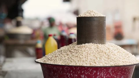 Can of overflowing maize kernels sold in an open African market. Stock Footage 346229083