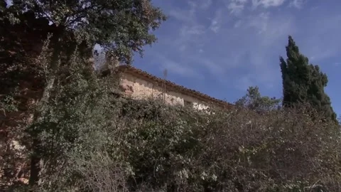 Can Robert back rear stone old house gimbal La Mola traveling Stock Footage 320547509