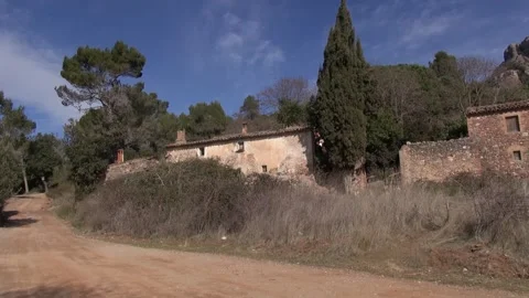 Can Robert road dirt path stone old facade front La Mola pan Stock Footage 320547532