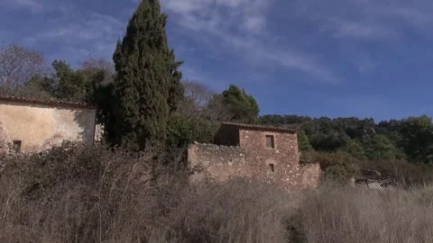 Can Robert stone old house gimbal La Mola bushes traveling Stock Footage 320547555