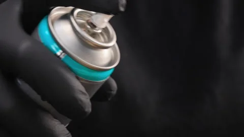 Can with spray in hands closeup Stock Footage 276686846