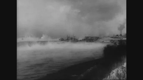CANADA - 1943: Troops board ship in a smoky harbor bound for Europe Stock Footage 339074235
