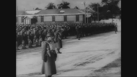 CANADA - 1943: Troops march past barracks and board a troop train Stock Footage 339074233