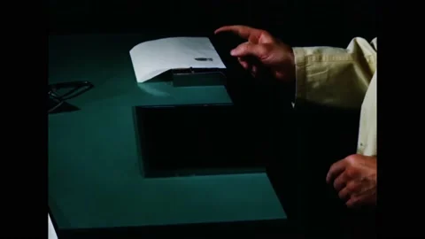 CANADA - 1951 - A technician tests some fingerprinting equipment and must remove Stock Footage 284719396
