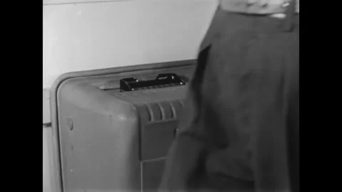CANADA - 1965 - Prison guards punch in for the evening shift and inmates working Stock Footage 340649548