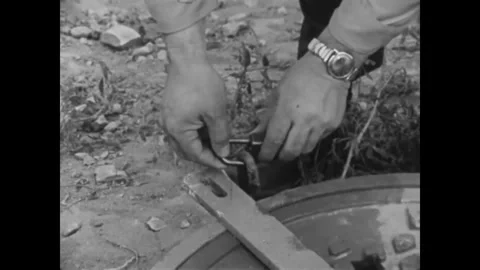 CANADA - 1965 - Two escaped convicts are found hiding in a sewer pipe. Stock Footage 340649640