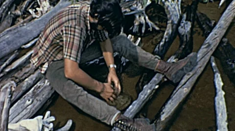 Canada 1970: man searching for metal in the water Stock Footage